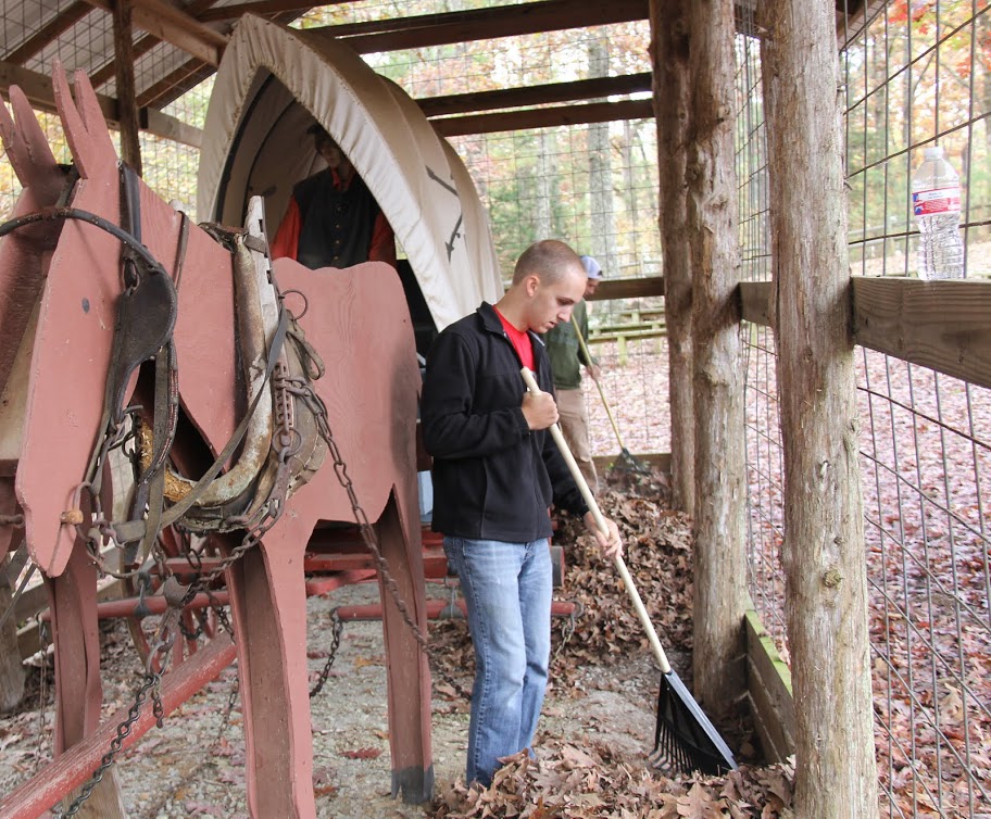 Dein Dean rakes up leaves inside a stable located at Britton Lane Battlefield on November 3, 2015.