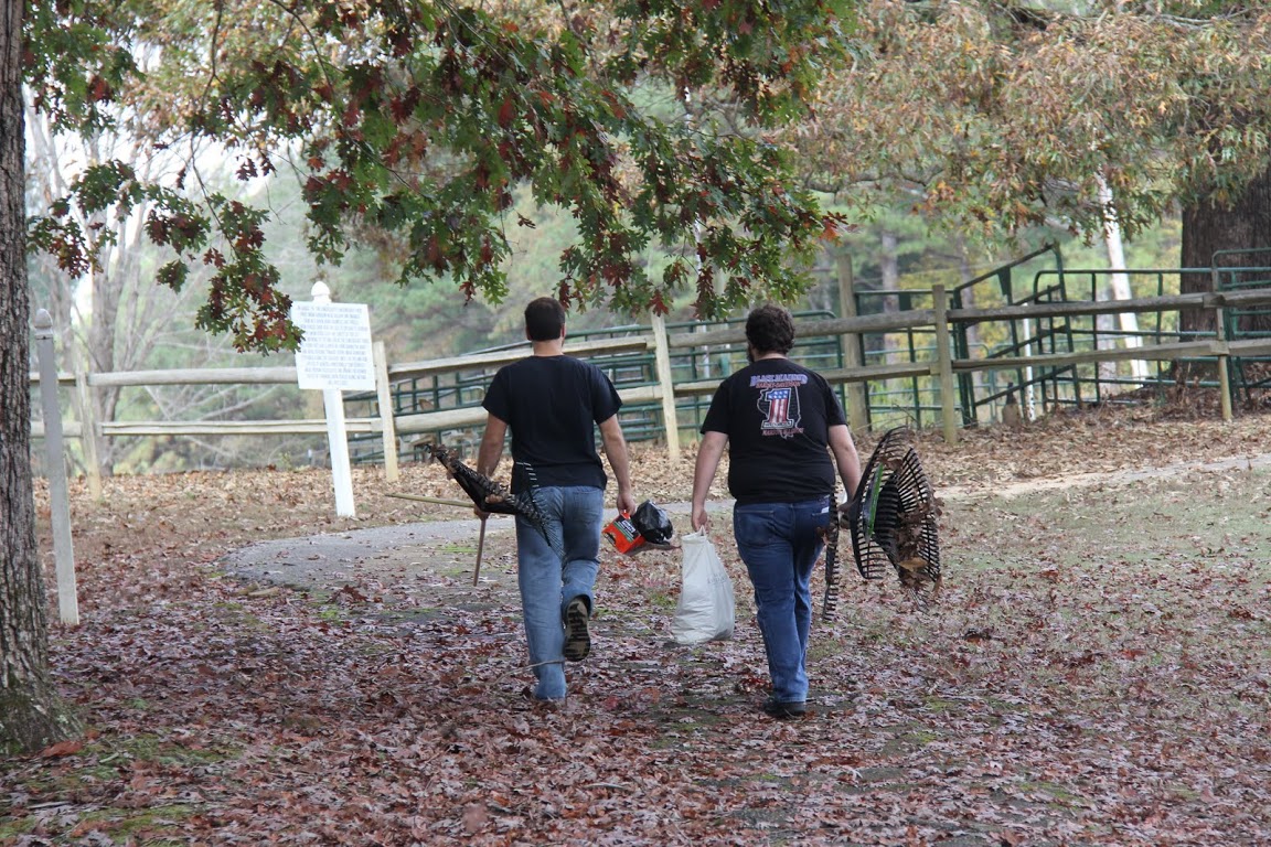 Allen Bradley (left) and Nicholas Hancock carry equipment back to history faculty members' vehicles at the end of the Phi Alpha Theta-sponsored community service project at Britton Lane Battlefield on November 3, 2015.