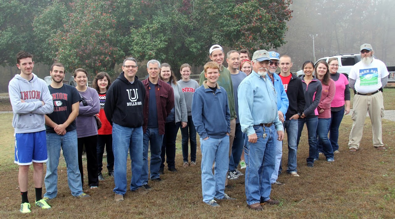 Participants in the history department's community service project join together with their hosts for a photo after being divided into four groups for hands-on cannon firings. Pictured in the photo are: (left to right) Logan Smith, Allen Bradley, Emily Littleton, Priscilla Porter, Dr. Keith Bates, Dr. David Thomas, Jessica Barton, Beth Adams, Gideon Ragland, Stephen Lewoczko, Dr. Henry Allen, Ali Renckens, Nicholas Hancock (behind Renckens), host Jim Weaver, Dr. Terry Lindley, Devin Dean, Katherine Cheshire, Jordan Sellers, Hannah Conway, and host James Price.
