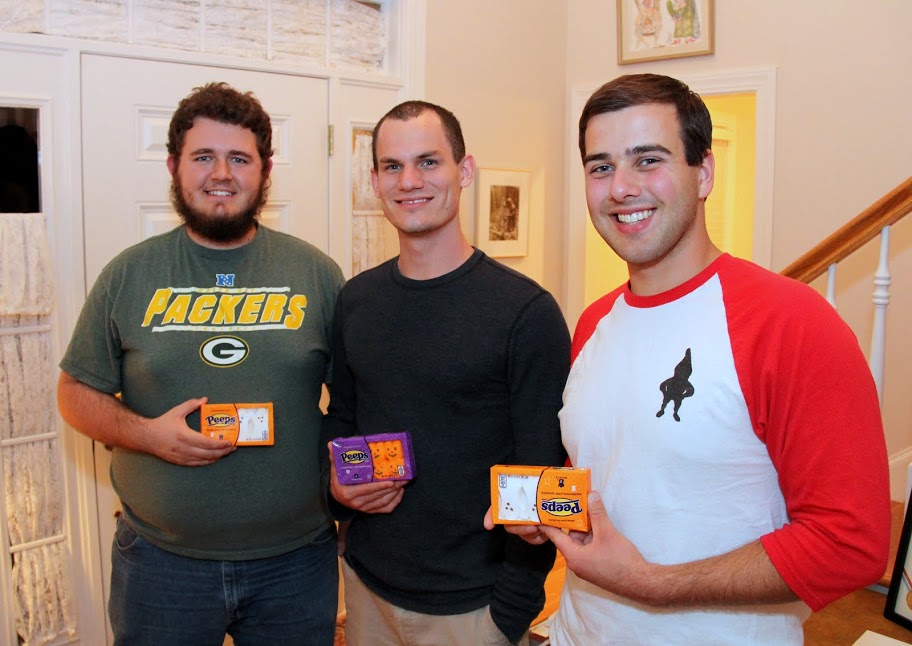 Nicholas Hancock, Jonmark Hetrick, and Allen Bradley show off their Peeps packages at the end of the Phi Alpha Theta Best Chapter Award pizza party on October 16, 2015.
