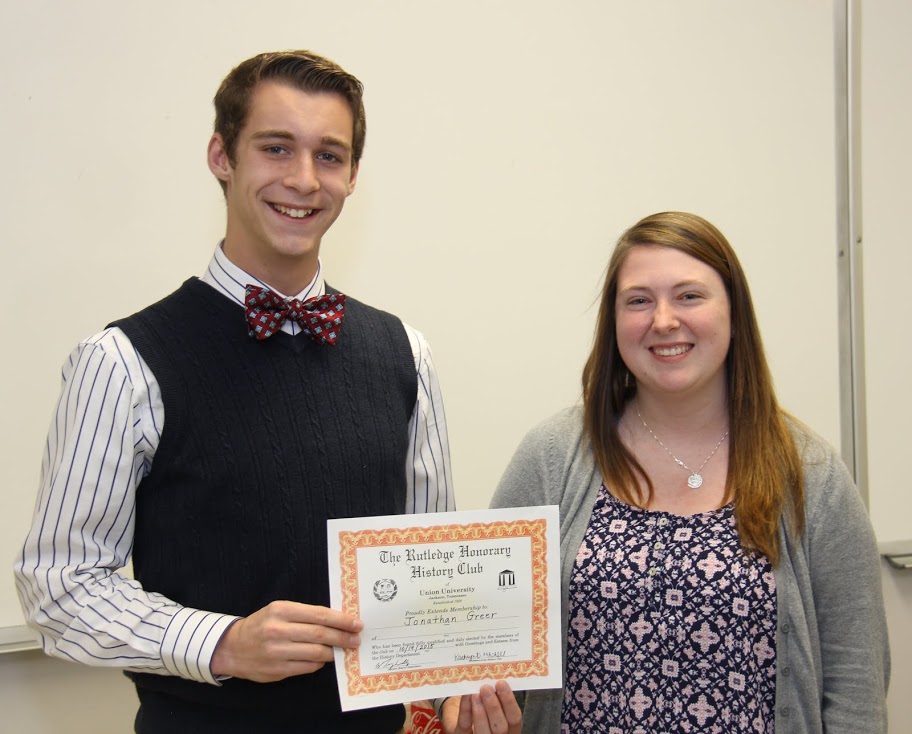 Newly inducted history club member Jonathan Greer displays his membership certificate while standing with Rutledge Honorary History Club President Kathryn Mitchell on October 19, 2015.
