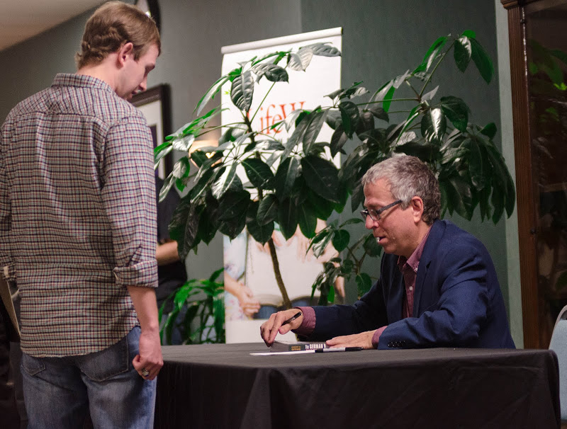 Dr. Robert Citino (right) does signs a book for Trebor Briley following his evening lecture on October 29, 2015.