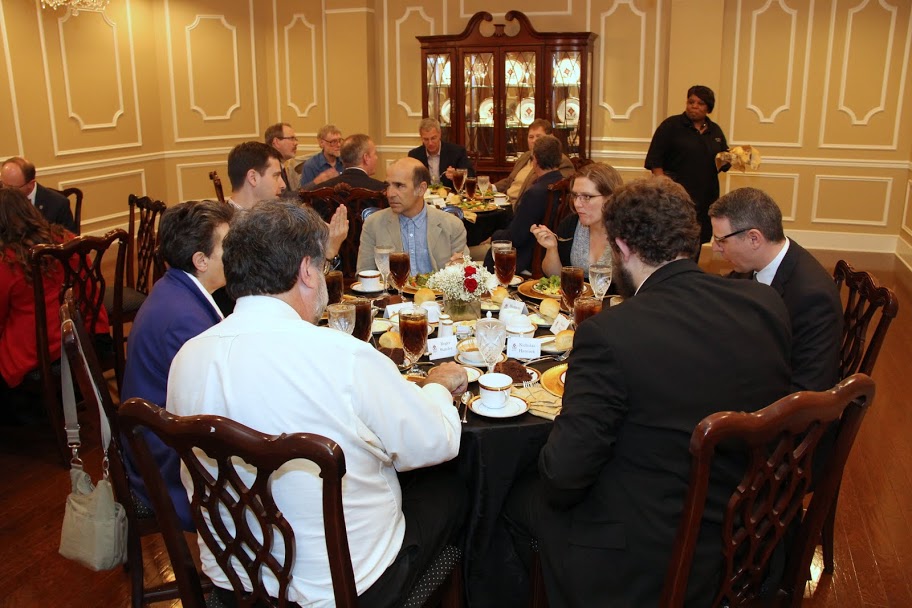 Guests enjoy delicious food and great conversation at the dinner in honor of Dr. Robert Citino, The Carls-Schwerdfeger History Lecturer, on October 29, 2015. Seated at the front table are (starting in the left foreground, and going clockwise) Professor Roger Stanley (wearing white shirt), Dr. Alice-Catherine Carls, Philip Carls, Dr. Michael La Rosa, Dr. Margaret Lewis, Dr. Keith Bates, and Nicholas Hancock (back to camera).