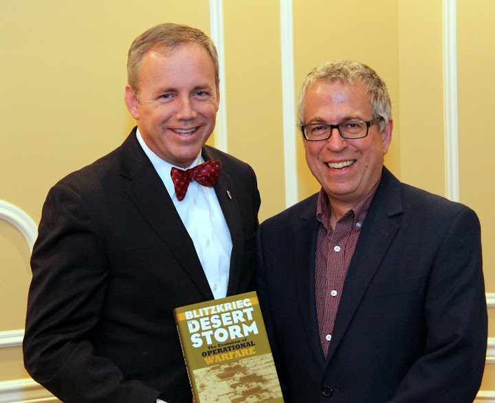 Union University President Dr. Samuel W. Dub  Oliver stands with historian Dr. Robert Citino after receiving a copy of one of Citino's books at a dinner in honor of history lecturer on October 29, 2015.