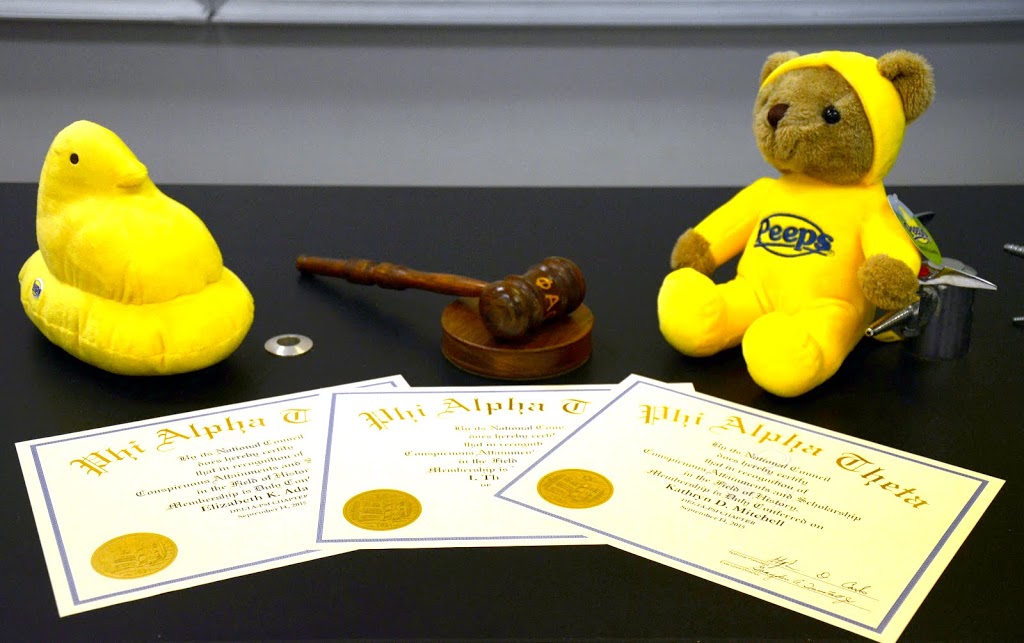 Phi Alpha Theta certificates of membership, along with Delta-Psi chapter symbols, form a counter display prior to the chapter's fall initiation/plenary meeting on September 14, 2015. Photo by Elizabeth Wilson
