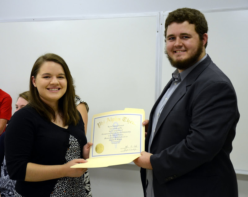 Jordan Sellers accepts her Phi Alpha Theta membership certificate from Delta-Psi President Nicholas Hancock at the Delta-Psi chapter's fall plenary meeting on September 14, 2015. Photo by Elizabeth Wilson
