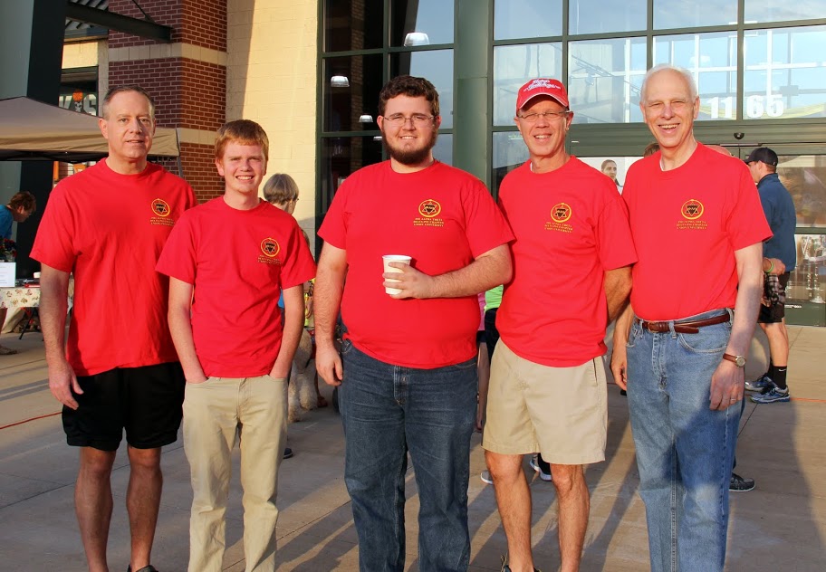 Phi Alpha Theta volunteers at the Racing So They Can Ride event on September 19, 2015, take time for a photo in front of Dick's Sporting Goods, the starting point for the morning's 5k and 10k races. They are (left to right) Dr. Henry Allen, Gideon Ragland, Nicholas Hancock, Robert Briley, and Dr. Stephen Carls.