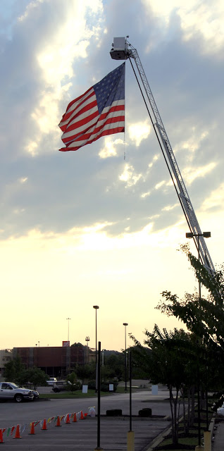 An American flag flies high in the sky on the morning of September 19, 2015, near the start/finish line of the Racing So They Can Ride event at Dick's Sporting Goods.
