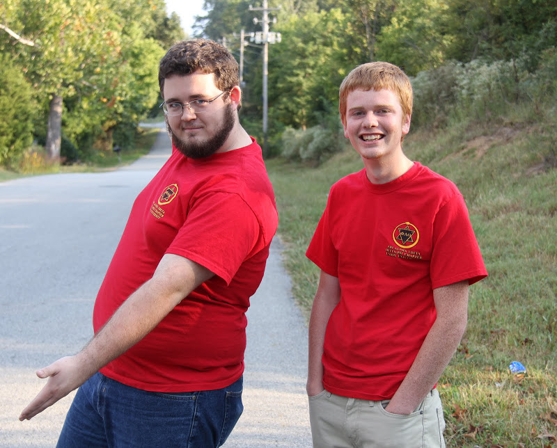 Phi Alpha Theta members Nicholas Hancock (left) and Gideon Ragland get ready to guide people along the race course at the Racing So They Can Ride 5k and 10k runs on September 19, 2015.