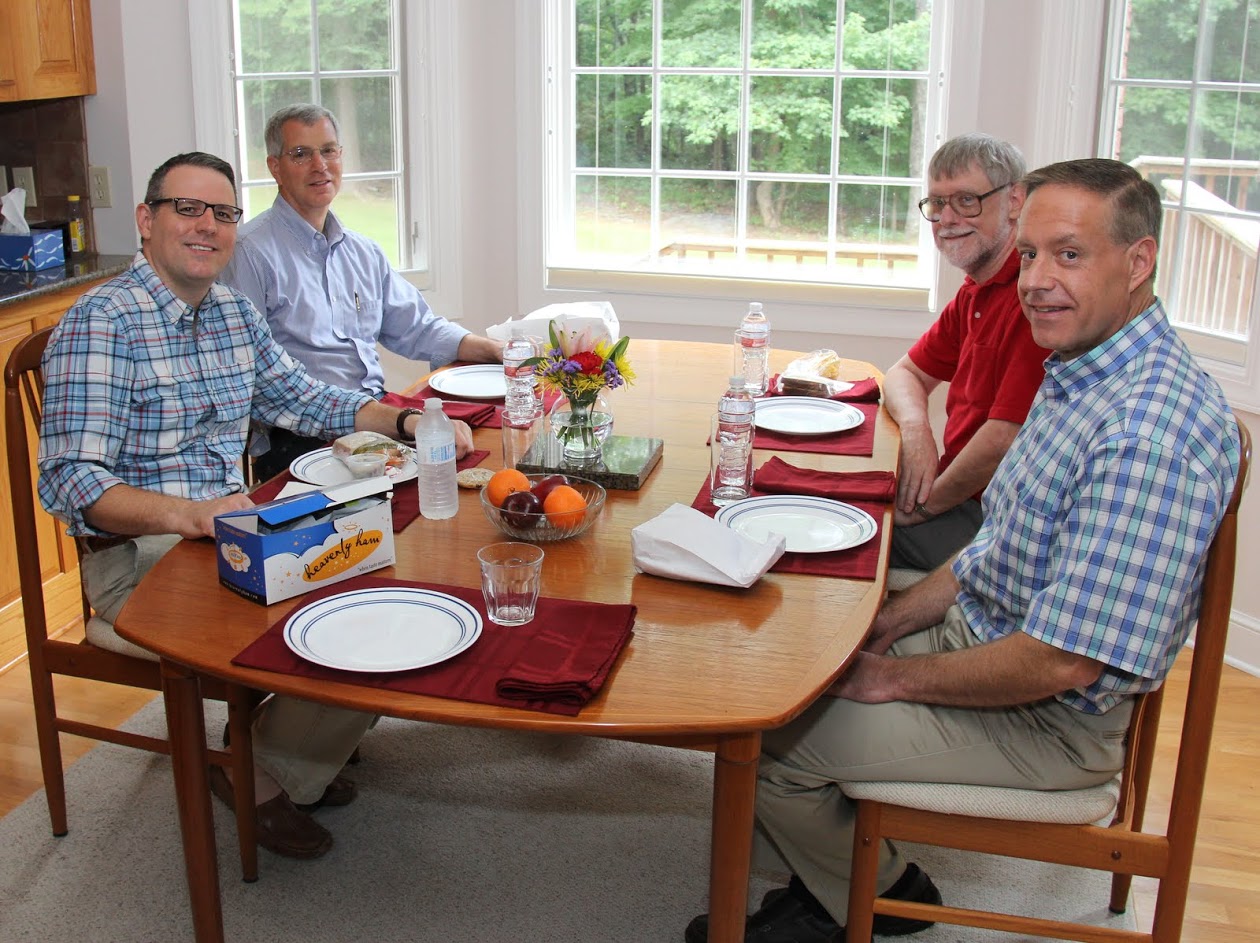 History faculty members get ready to have lunch at Dr. Stephen Carls's home as part of a department meeting on August 11, 2016. They are (starting on the left, going clockwise) Dr. Keith Bates, Dr. David Thomas, Dr. Terry Lindley, and Dr. Henry Allen.