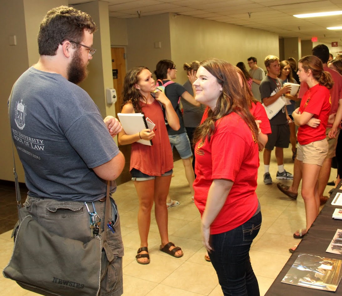 Phi Alpha Theta President Jordan Sellers (front right) talks to history major Christopher Hearn at the Student Organizations Fair on August 22, 2016.