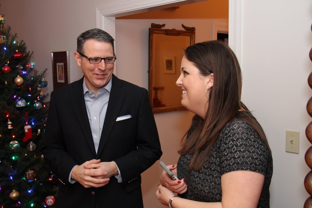 Dr. Keith Bates talks with history major Emily Littleton at the start of the French Christmas dinner at Dr. Stephen Carls's home on December 10, 2016.