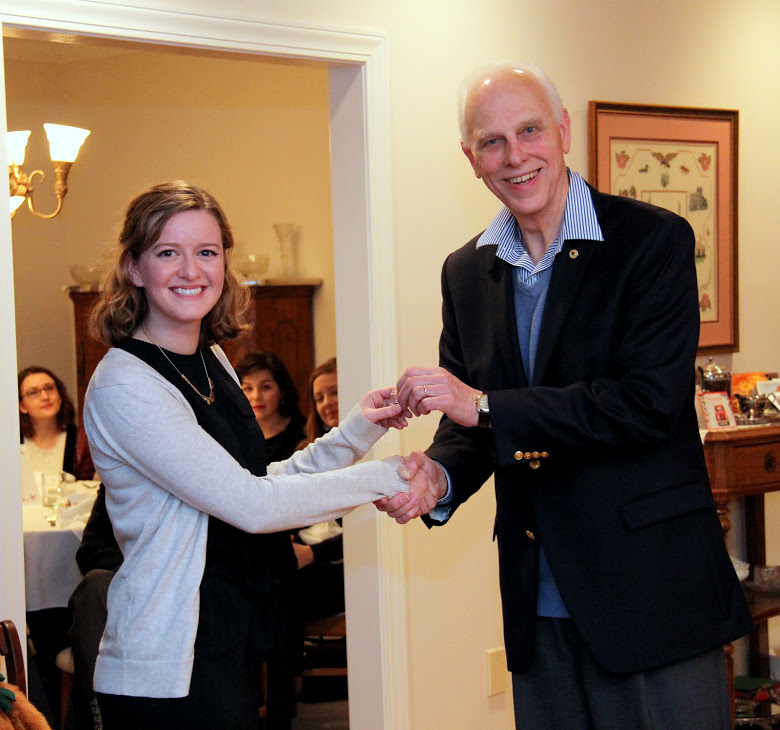 Phi Alpha Theta member Beth Adams receives a Tennessee Great War Commission pin from Dr. Stephen Carls at the history department's Christmas dinner for her service at a Great War Symposium event at Jackson's First Presbyterian Church on November 4, 2016.