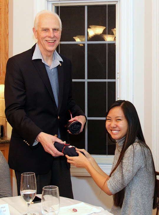 Katherine Cheshire accepts a Phi Alpha Theta T-shirt from Dr. Stephen Carls at the history department's French Christmas dinner on December 10, 2016.