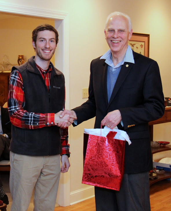 Graduating history major Luke Adkins (left) receives the congratulations of Dr. Stephen Carls at the department's Christmas dinner on December 10, 2016, for his successful completion of a bachelor of science program at Union University.