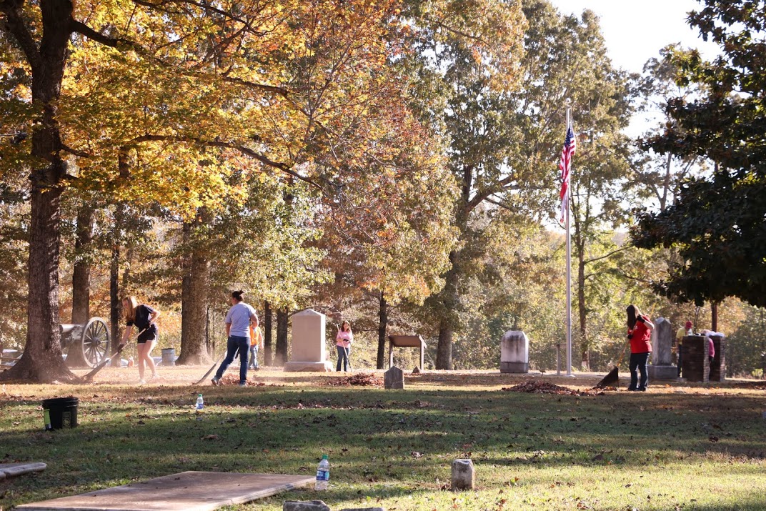 Participants in the Phi Alpha Theta/History Department community service project at Salem Cemetery on November 1, 2016, rake leaves and paint the cemetery entry gate (on the right). Photo by Elizabeth Wilson