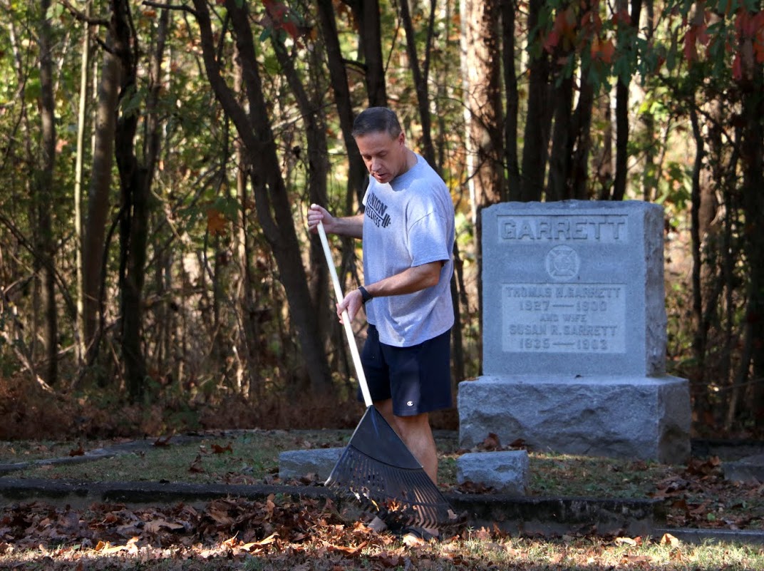 Dr. Henry Allen rakes leaves at Salem Cemetery on November 1, 2016, as a part of Union's 