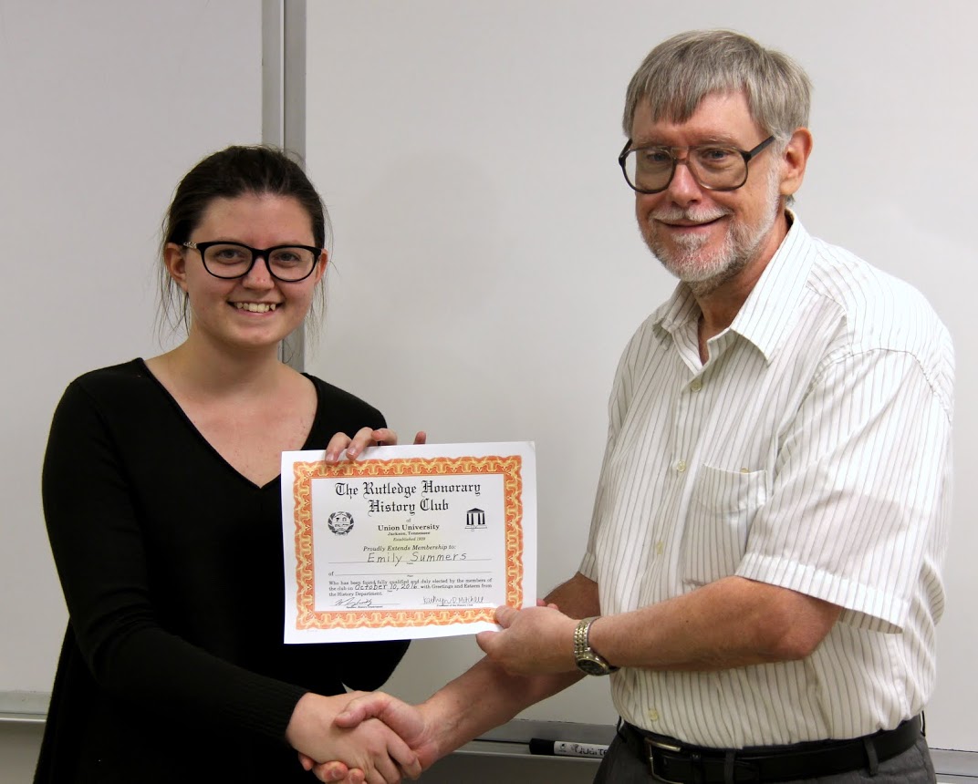 Emily Summers accepts her history club membership certificate from Dr. Terry Lindley on October 10, 2016.