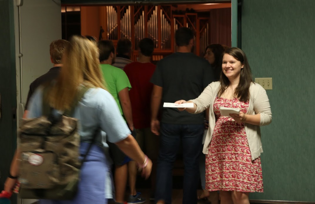 Phi Alpha Theta member Jordan Sellers hands out a program to an attendee for the evening lecture by Dr. Sean McMeekin who served as the Carls-Schwerdfeger History Lecturer on October 3, 2016. Photo by Elizabeth Wilson