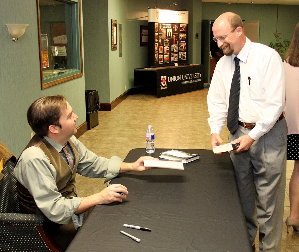 Dr. Sean McMeekin (seated) talks to Union University history alumnus Greg Allison during a book signing following McMeekin's evening lecture on October 3, 2016.
