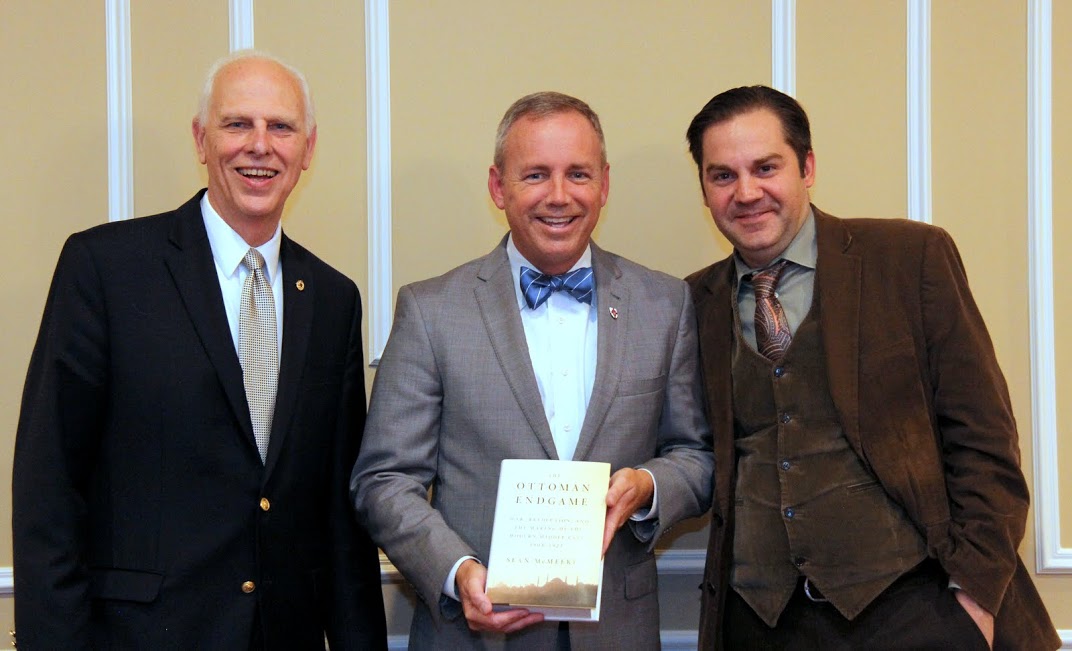 Drs. Stephen Carls (left to right), Samuel W. Dub Oliver, and Sean McMeekin smile for the camera during the presentation of one of Professor McMeekin's books to Dr. Oliver at a dinner on October 3, 2016.