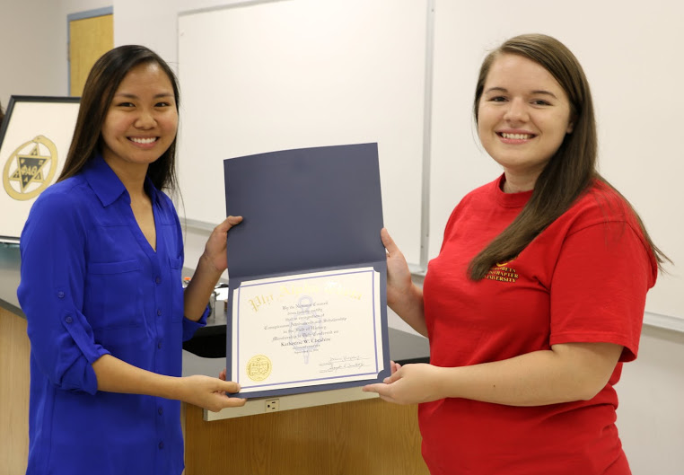 Katherine Cheshire (left) receives her Phi Alpha Theta membership certificate from Delta-Psi President Jordan Sellers during the chapter's fall initiation ceremony on September 13, 2016. Photo by Elizabeth Wilson