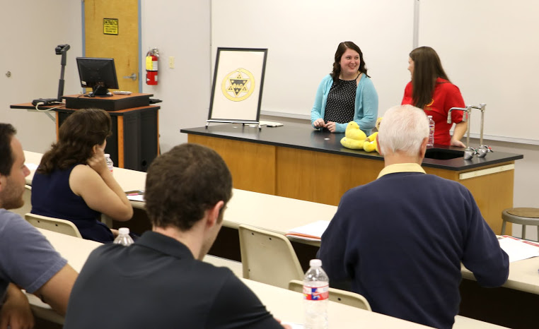 Delta-Psi President Jordan Sellers (wearing red T-shirt) talks with Vice President Kathryn Mitchell (wearing turquoise sweater) during the chapter's plenary meeting on September 13, 2016. Photo by Elizabeth Wilson