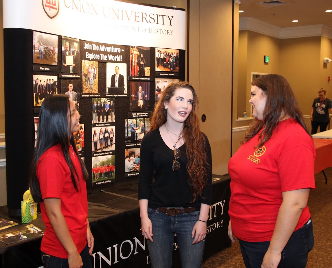 Phi Alpha Theta members Katherine Cheshire (left) and Jessica Barton (right) talk to history major Mikayla Simpson at the Big Top Campus Life Fair on August 20, 2017.