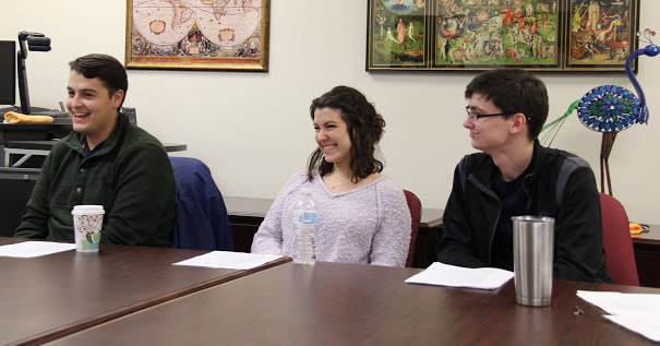 Attendees at Seth Reid's history honors thesis defense smile during one of the session's light moments. They are (left to right) Jake Leach, Kaylee Reid, and Brandon Harper.
