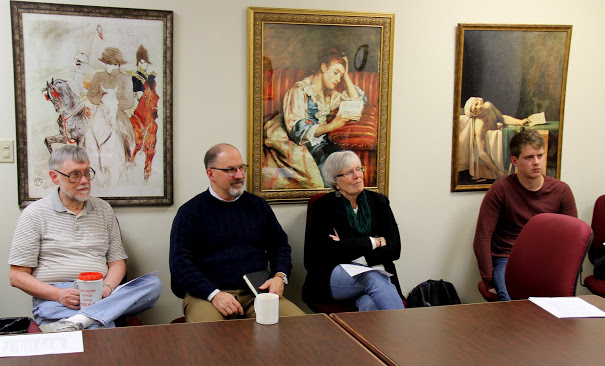 Attendees listen to Seth Reid answer a question at his honors thesis defense on December 8, 2017. They are (left to right) Dr. Terry Lindley, Dr. Scott Huelin, Nancy Thomas, and Russell Richardson.
