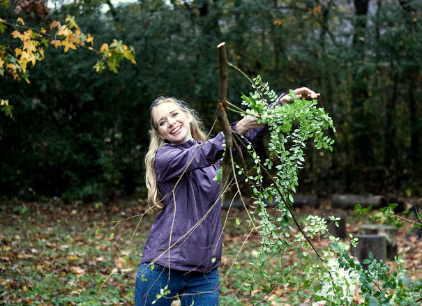 Ali Renckens throws a branch onto a pile at the history department's community service project at Liberty Garden Park & Arboretum on November 7, 2017. Photo by Janelle Vest