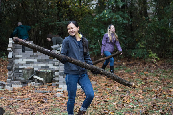 Phi Alpha Theta member Katherine Cheshire carries a tree branch to a pile for pickup at Liberty Garden Park on November 7, 2017. Photo by Janelle Vest