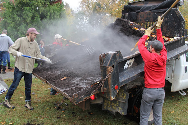 Luke Sower (front left), Matthew Latham (to the right of Sower), and Seth Reid (right, back to camera) remove mulch from a City of Jackson truck during the history department's community service project at Liberty Garden Park on November 7, 2017.