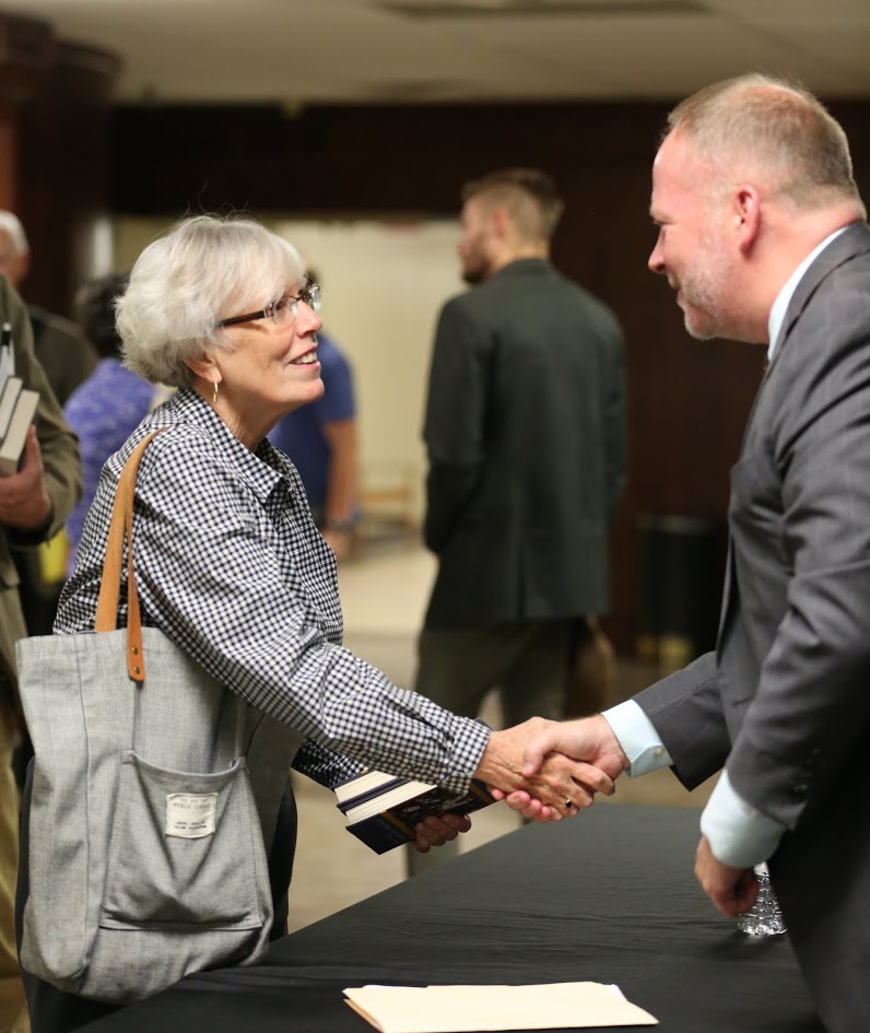Nancy Thomas greets Dr. Bruce Gordon during a book signing following Gordon's lecture about What Happened to the Bible in the Reformation? on October 19, 2017. Photo by Kristi Woody
