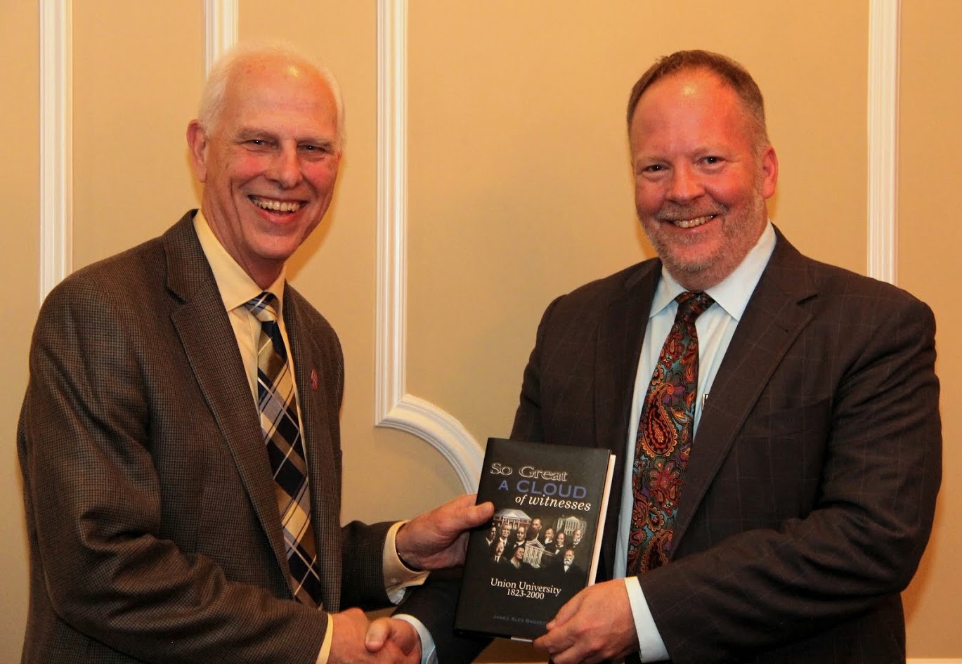Dr. Stephen Carls (left) presents a copy of SO GREAT A CLOUD OF WITNESSES: UNION UNIVERSITY, 1823-2000 to Dr. Bruce Gordon at a dinner in Gordon's honor on October 19, 2017.