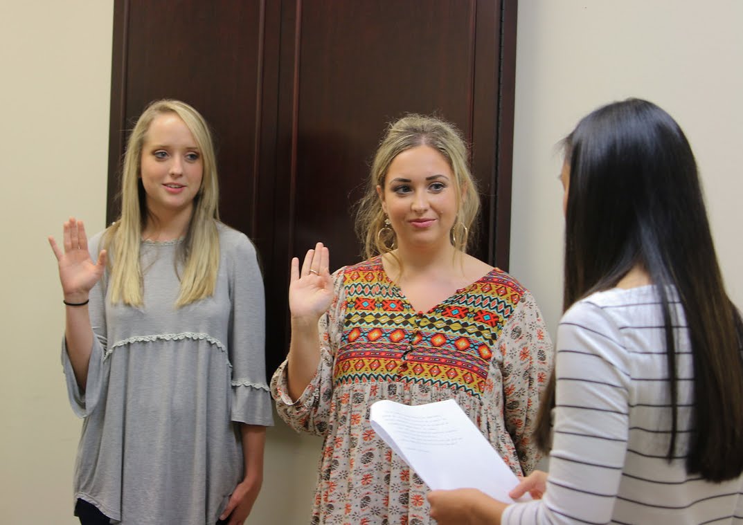 Delta-Psi Vice President Katherine Cheshire (right, back to camera) leads Nakota Wood (left) and Marylee Barker in the initiation ceremony at the fall Phi Alpha Theta plenary meeting on September 14, 2017. Photo by Hannah Kate Heckart