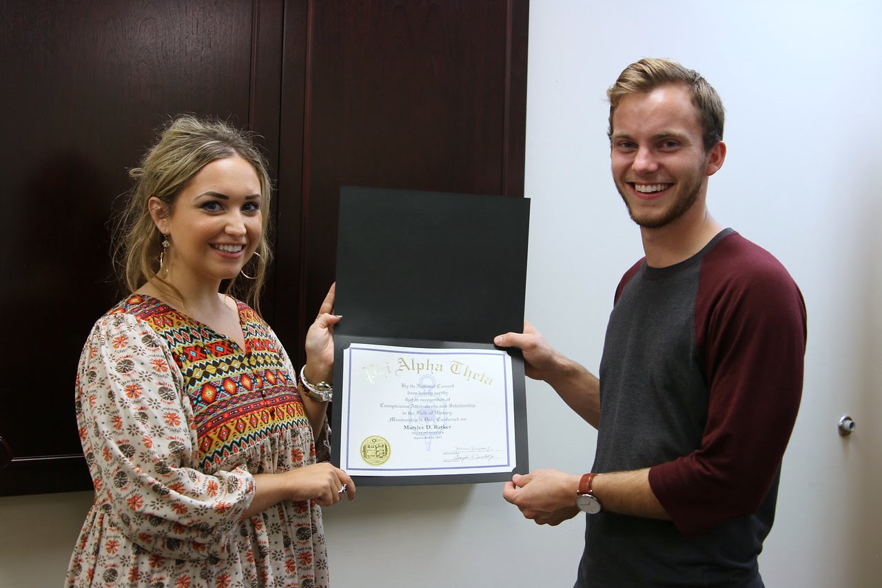 Delta-Psi Chapter President Seth Reid presents Marylee Barker with her Phi Alpha Theta certificate of membership on September 14, 2017. Photo by Hannah Kate Heckart