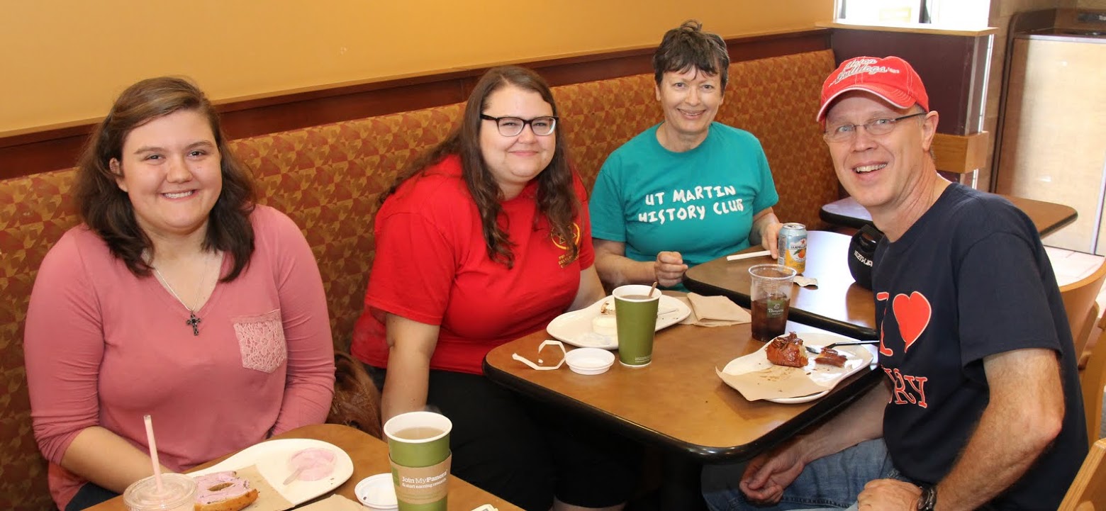 Volunteers representing Phi Alpha Theta at the Racing So They Can Ride races enjoy breakfast at a local Panera Bread restaurant following the races on September 16, 2017. They are (left to right) Cheyanne Harber, Jessica Barton, Dr. Alice-Catherine Carls, and Robert Briley.