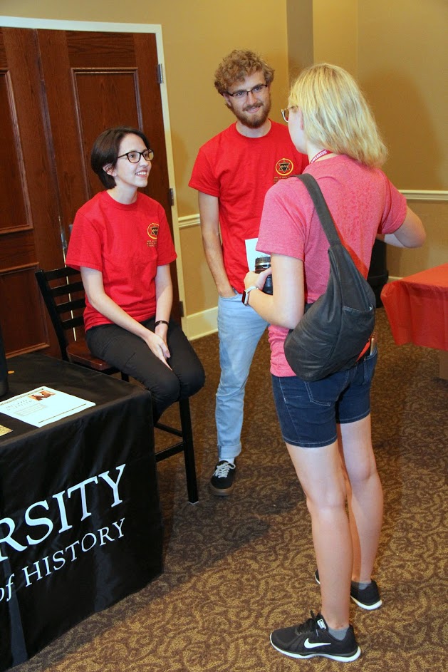 Phi Alpha Theta chapter officers Lauren Butler (left) and Luke Sower (center) talk to a student at the Campus Life Fair on August 19, 2018.