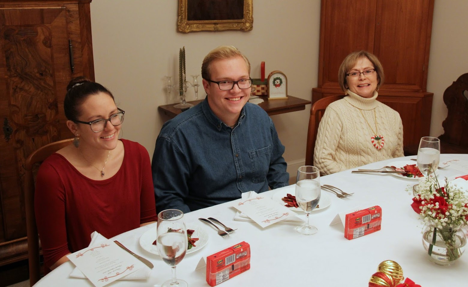 Katie Allison (left to right), Nathan Heatherly, and Becky Lindley are ready to start the first course of their meals at the Phi Alpha Theta French Christmas dinner on December 8, 2018.