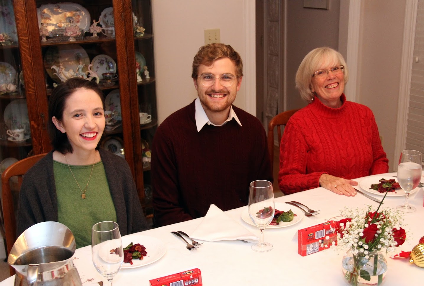 Lauren Butler (left to right), Luke Sower, and Nancy Thomas prepare to enjoy their dinners at the Phi Alpha Theta French Christmas dinner on December 8, 2018.