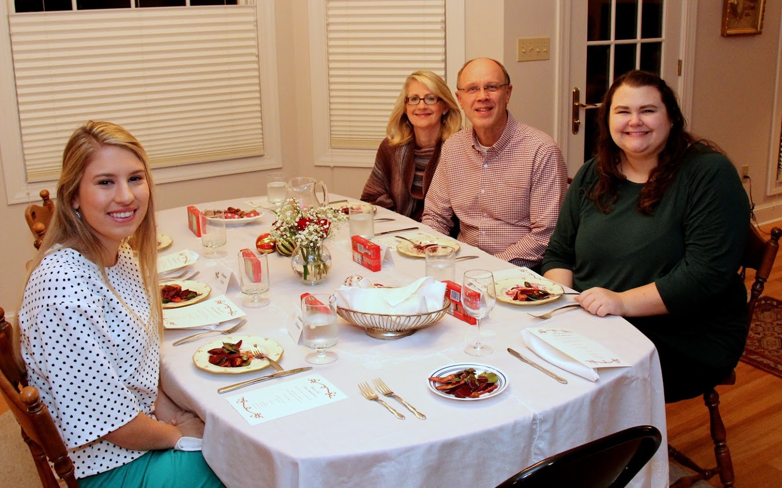 Attendees at the Phi Alpha Theta Christmas dinner smile as they prepare to begin their first course on December 8, 2018. They are (left to right) Addison Osborne, Brenda Briley, Robert Briley, and Jessica Barton.