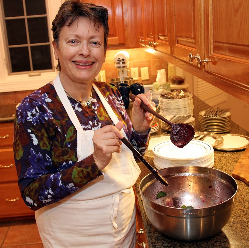 Dr. Alice-Catherine Carls shows off the wooden spoons that her daughter Elizabeth crafted as she prepares a red beet salad at the French Christmas dinner on December 8, 2018.