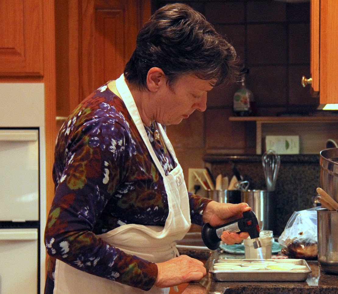 Dr. Alice-Catherine Carls caramelizes sugar on crèmes brulées at the Phi Alpha Theta French Christmas dinner on December 8, 2018.