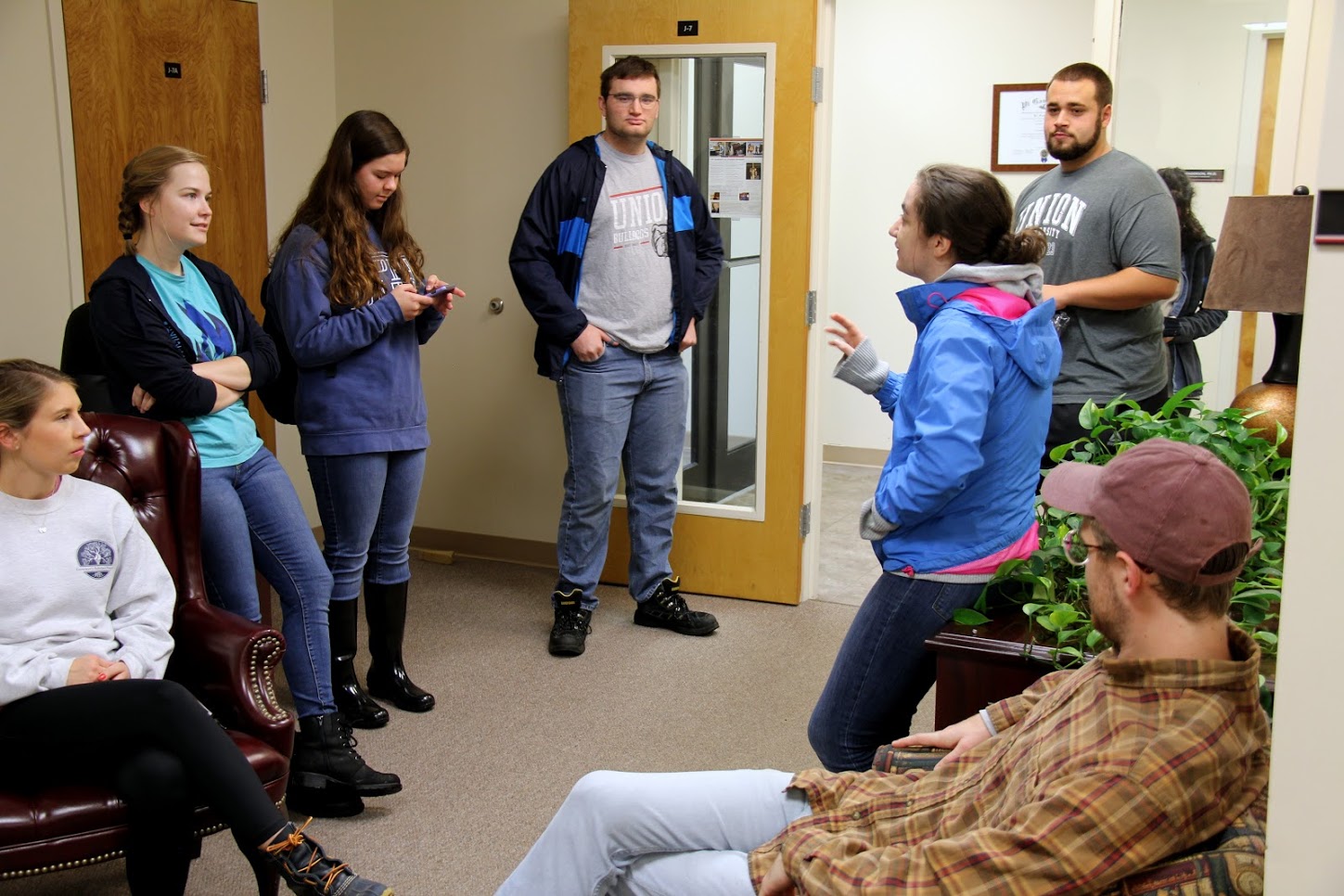 Participants in the history department's Day of Remembrance community service project wait in the Jones Suite of the PAC building for the event to begin. They are (starting on the left, going clockwise) Addison Osborne, Megan Ledbetter, Rachel Durham, Miles Randall, Nicholas Terra, Leah Atkins, and Luke Sower.