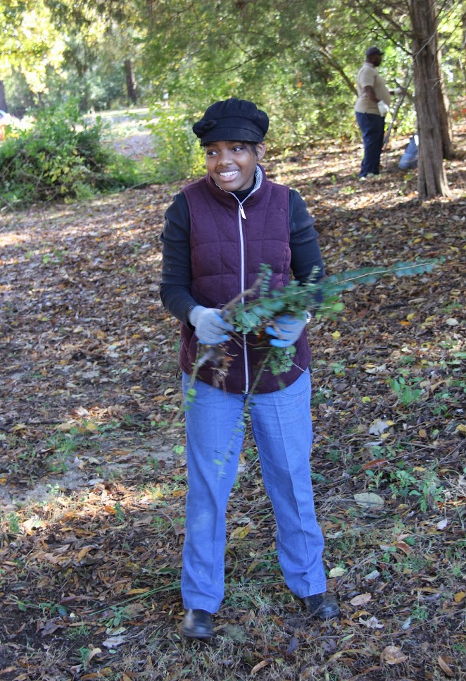 Tranae Newsome gathers up branches in the wooded area of Liberty Garden Park during the history department's community service project there on November 6, 2018. Photo by Kristi Woody