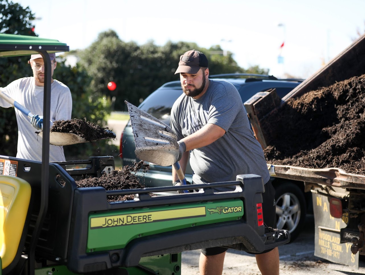 Luke Sower (left) and Nicholas Terra load mulch onto a utility vehicle during the history department's community service project at Liberty Garden Park on November 6, 2018. Photo by Kristi Woody
