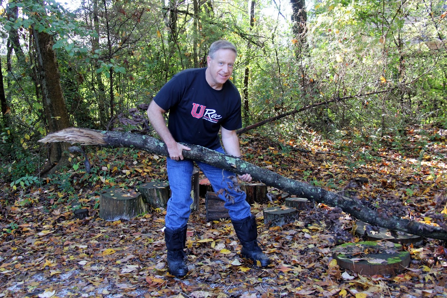Dr. Henry Allen removes a large branch from the wooded area of Liberty Garden Park and Arboretum during a Phi Alpha Theta/Rutledge Honorary History Club-sponsored community service project on November 6, 2018.
