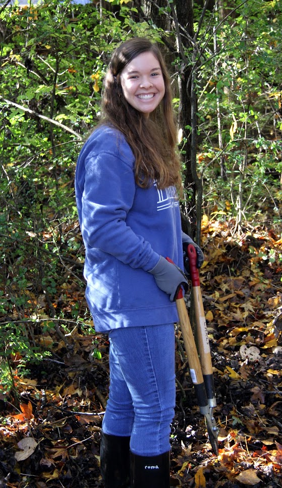 Rachel Durham uses a pruning lopper to clear out brush in the wooded area of Liberty Garden Park as part of Union University's Day of Remembrance on November 6, 2018.