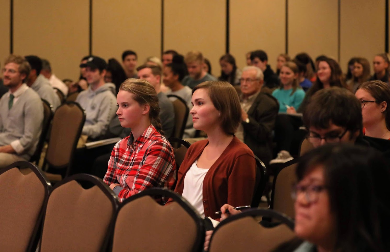 Attendees listen to Professor Melvyn Leffler speak on Harry Truman and the Origins of the Cold War as the Carls-Schwerdfeger History Lecturer on the afternoon of October 22, 2018. Seated in the second row are Katie Simpson (third from right) and Peytyn Moses (second from right). Photo by Kristi Woody